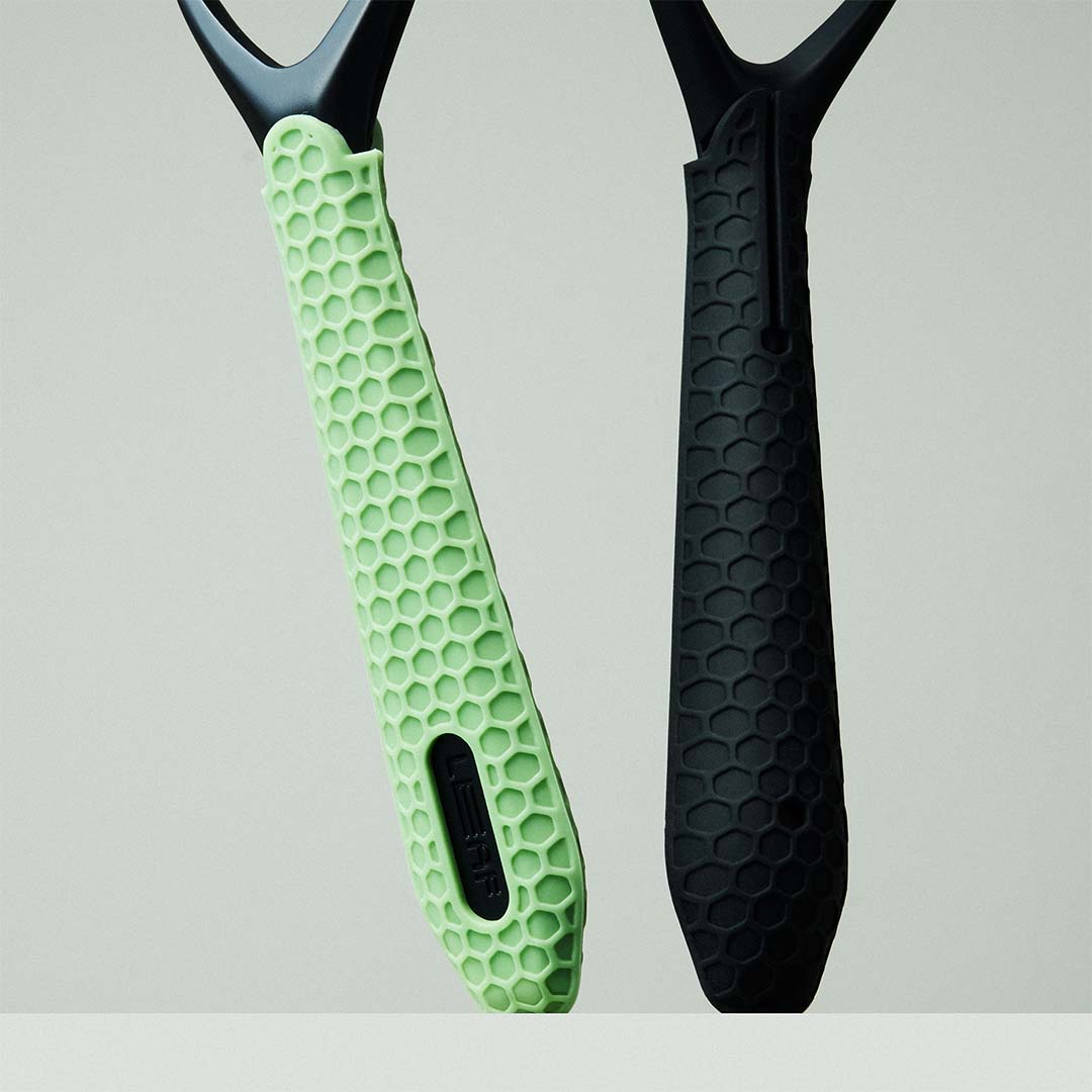 Two Razors with green and black sleeves on a light gray background