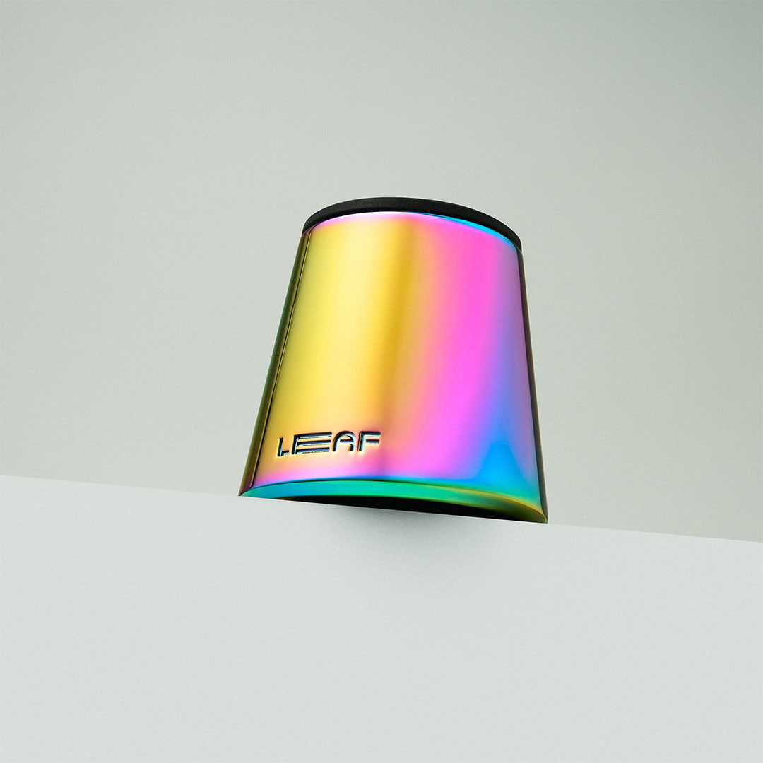Prism stand with 'LEAF' branding on a light gray background