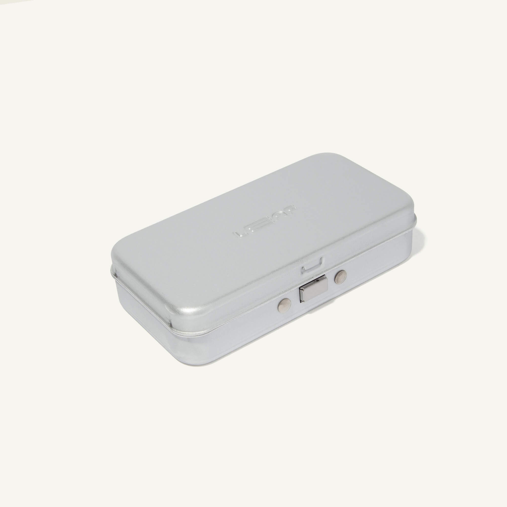 Silver case for the single-edge razors, closed, on a white background.