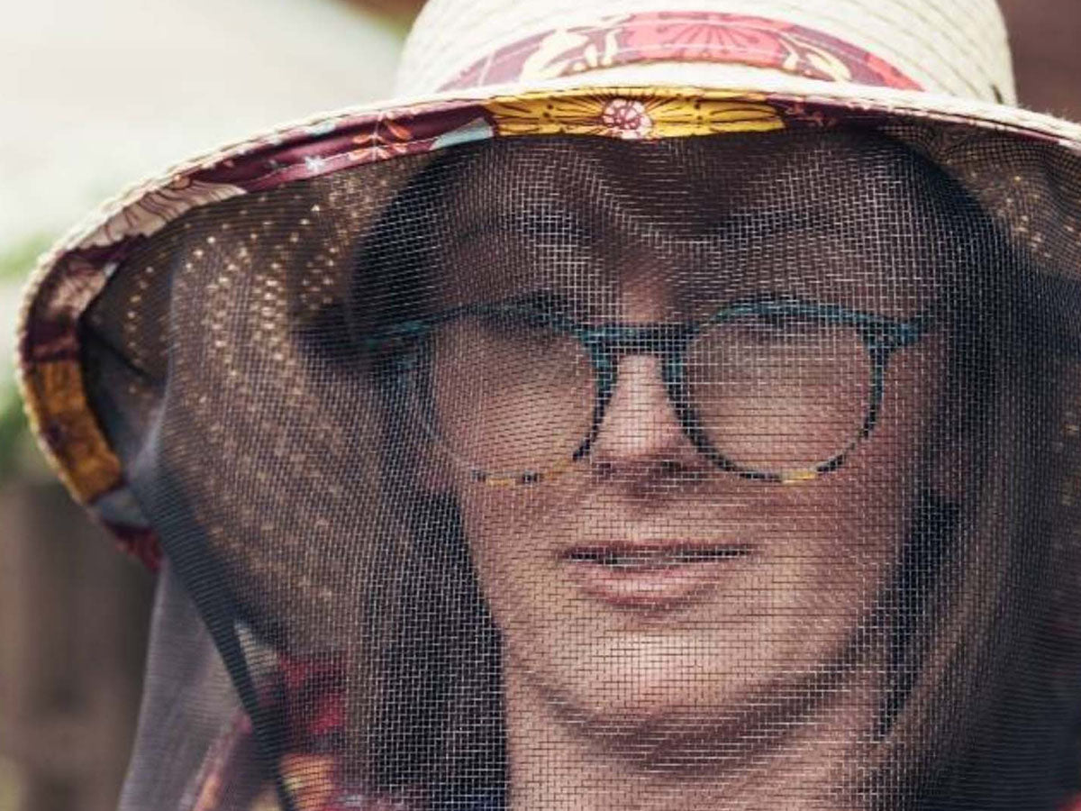 Beekeeper in a netted hat