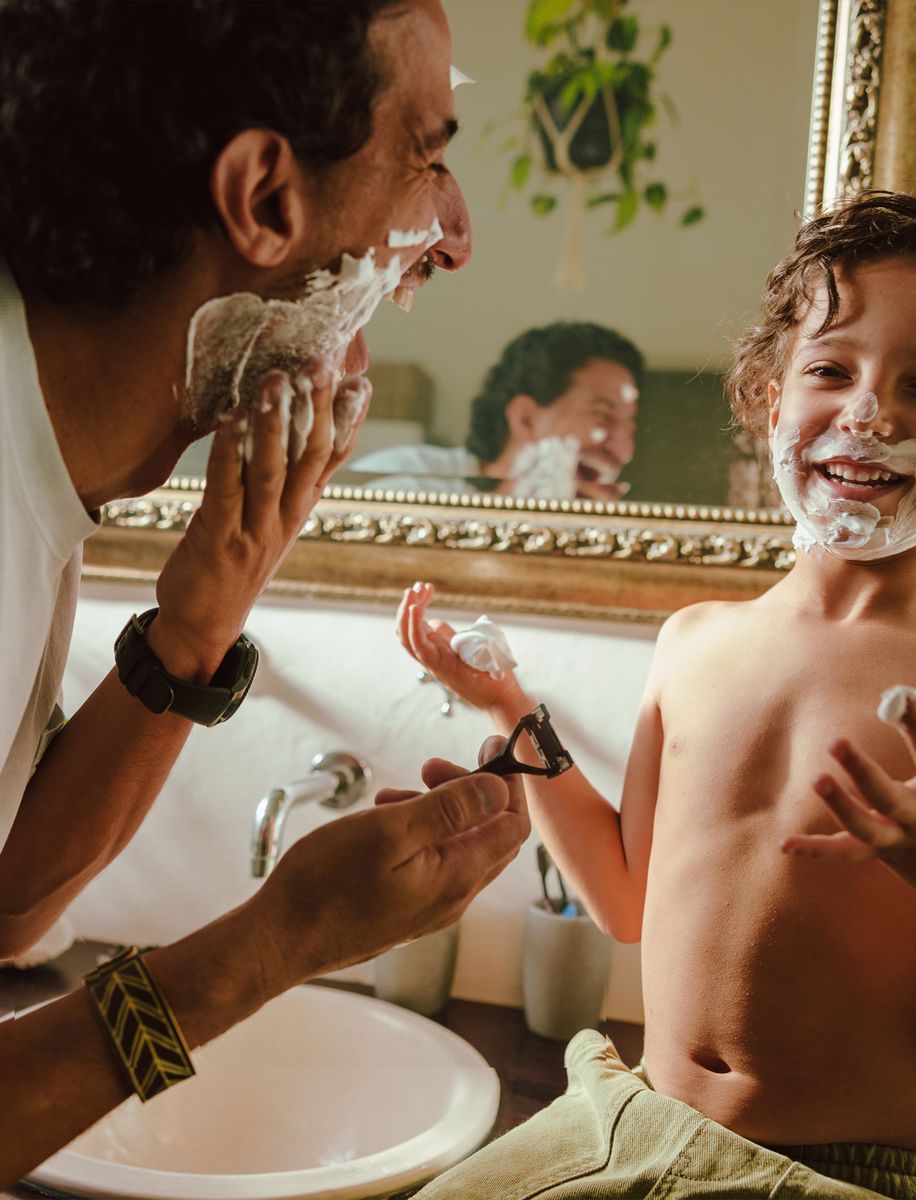 Father and son shaving together