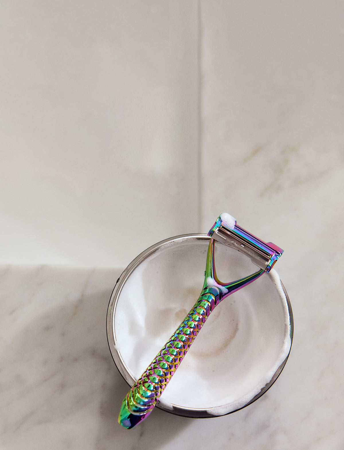 Multicolored skin peeler on a white surface