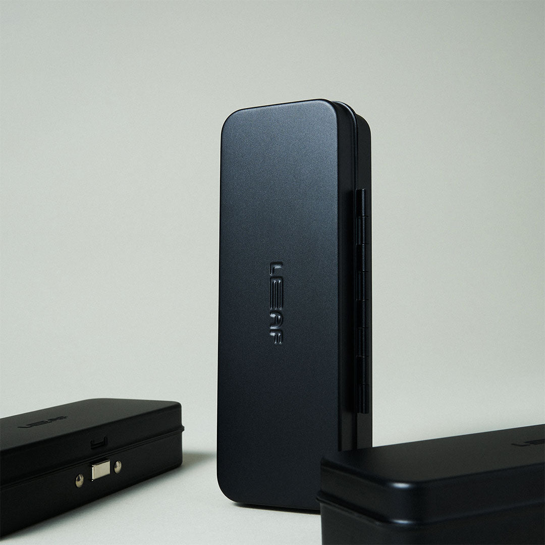 Black electronic device with a USB port on a light gray background