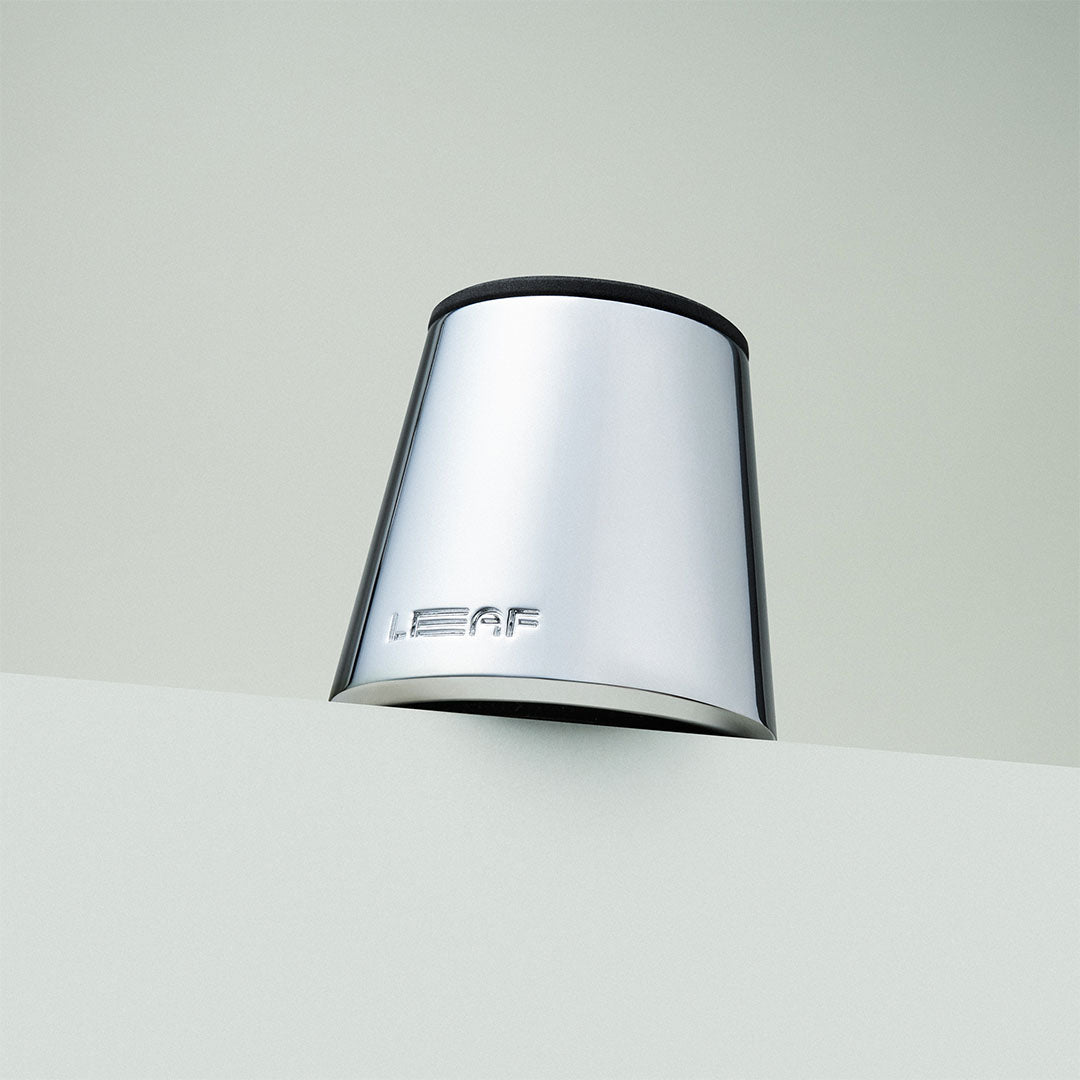 Chrome stand with 'LEAF' branding on a light gray background