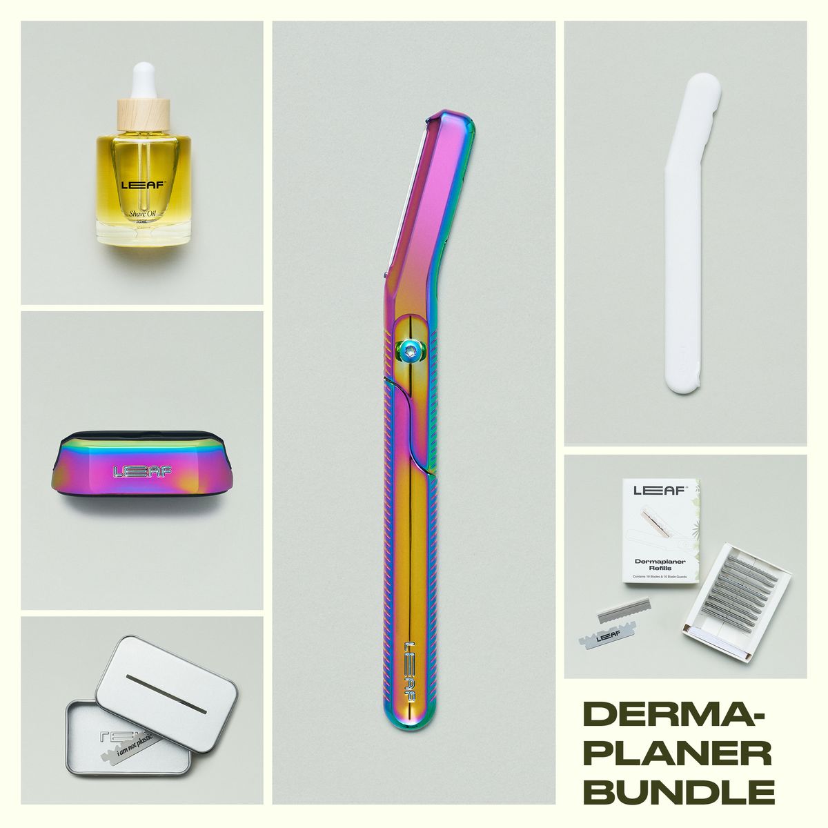 Leaf Shave Dermaplaner bundle in prism finish including handle, refill blades packaging, stand, white travel cover, recycling tin, and glass shave oil bottle on grey background