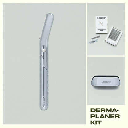 Leaf Shave Dermaplaner kit in chrome finish including handle, refill blades packaging, and stand on grey background