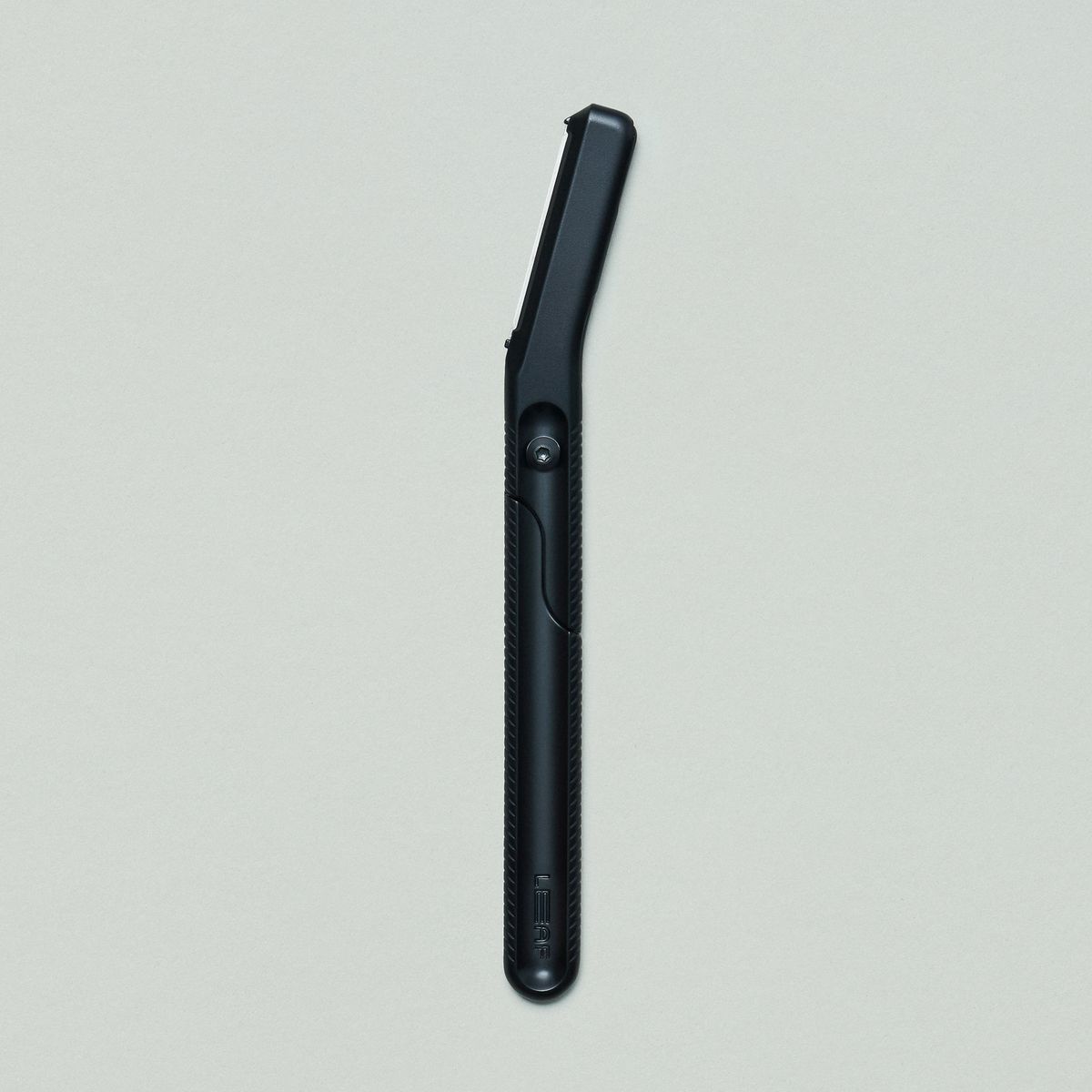 Black dermaplaner on grey background