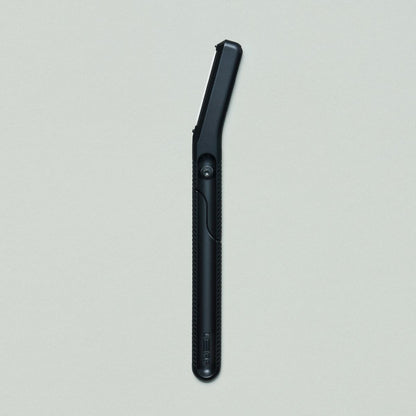 Black dermaplaner on grey background