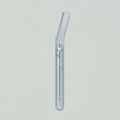 Chrome dermaplaner on grey background