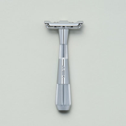 Chrome single edge razor on grey background