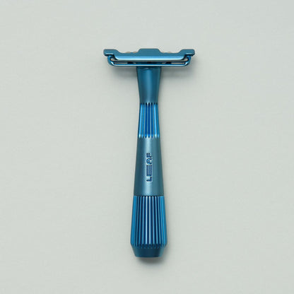 Glacier, light blue single edge razor on grey background