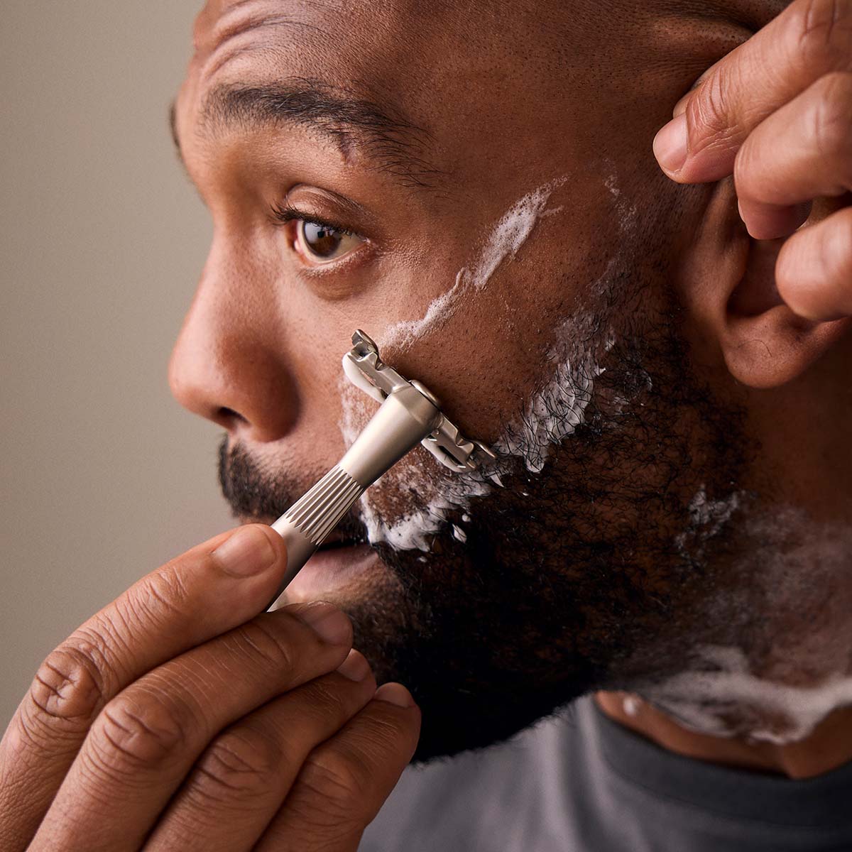 HOVER Shaving above beard line with a silver single edge razor