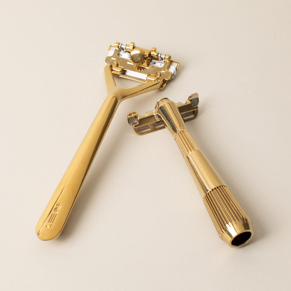 Leaf and single edge razor displayed side by side in gold