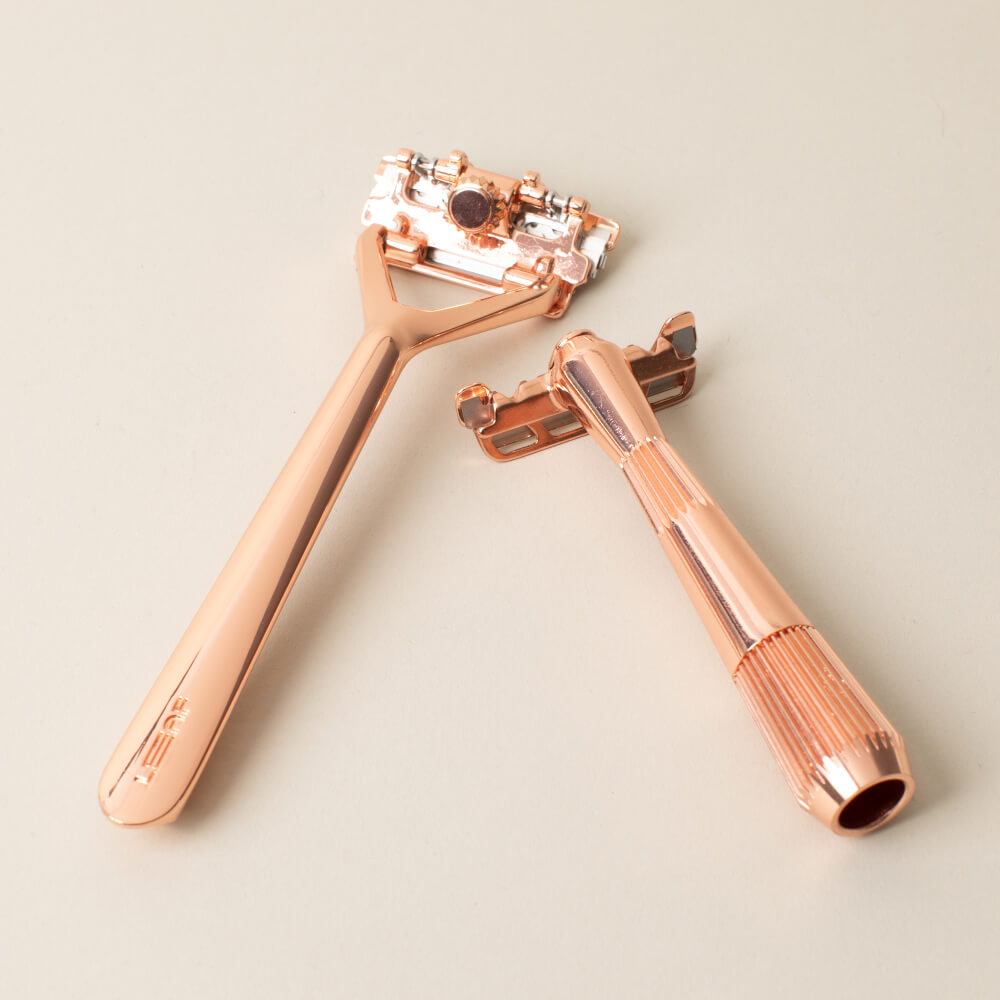 Leaf and single edge razor displayed side by side in rose gold