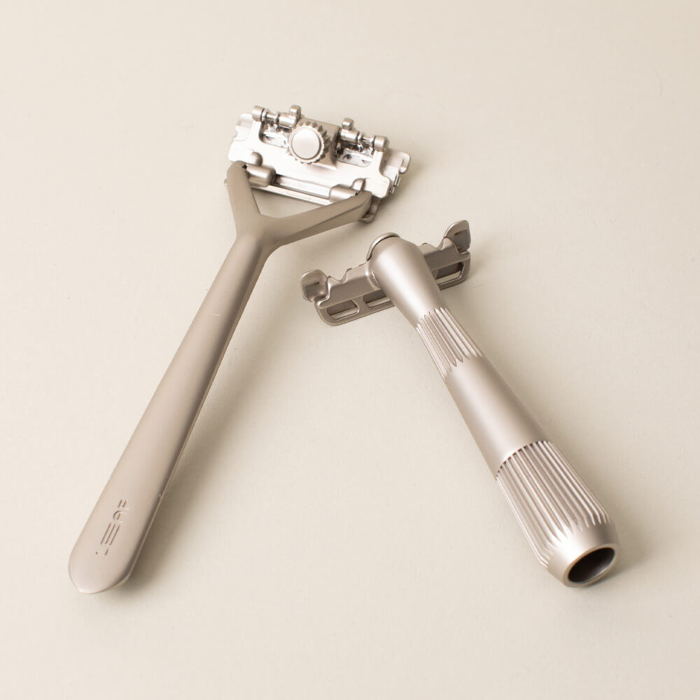 Leaf and single edge razor displayed side by side in silver