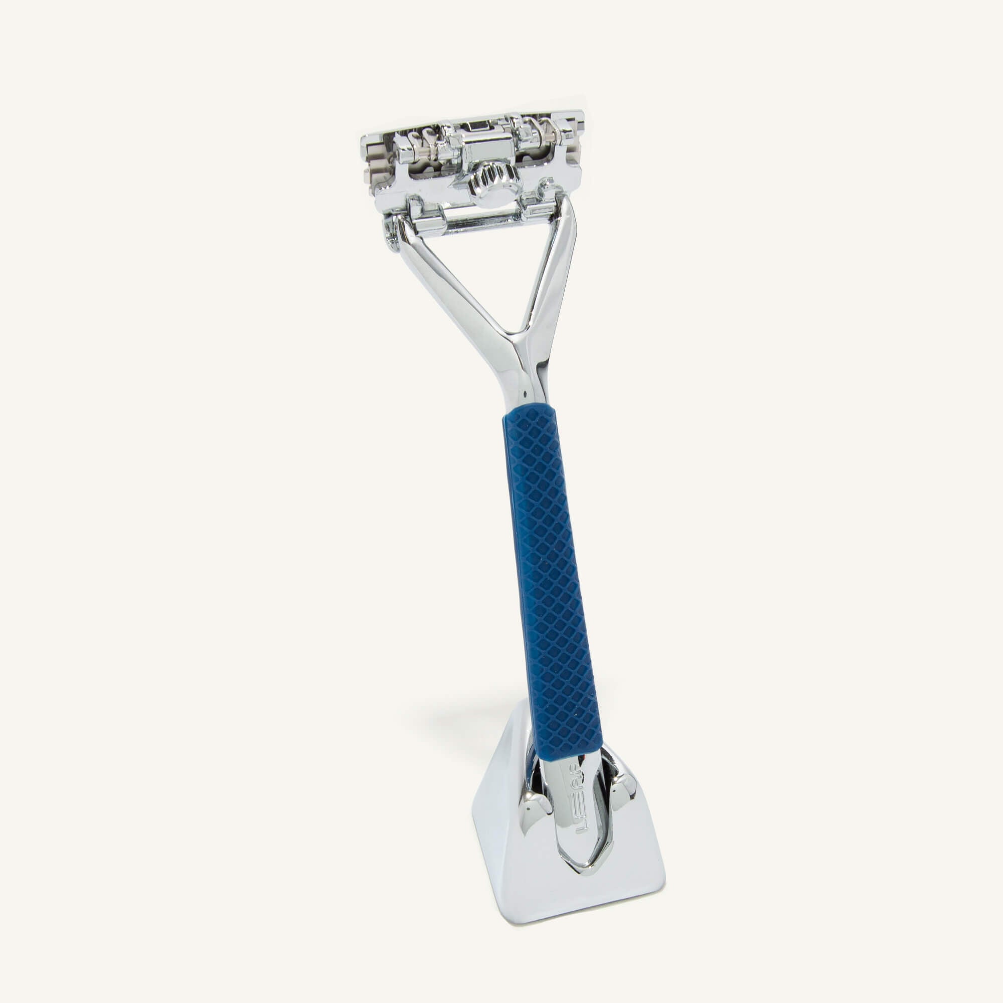 Chrome Leaf razor and stand, with a Blue grip sleeve on it.