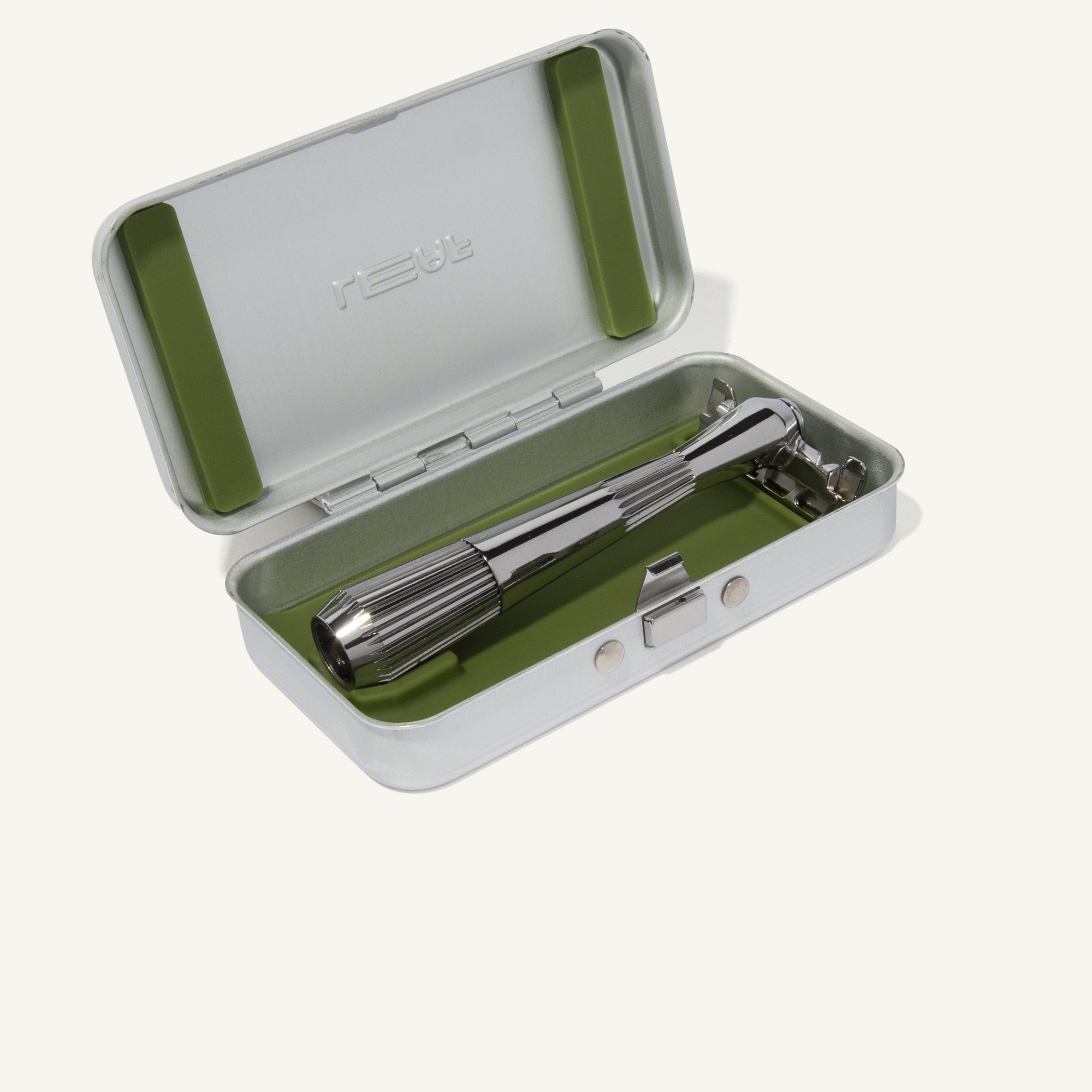 Silver case for the single-edge razors, open with a chrome razor laying inside, on a white background.